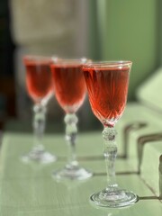 Pouring several glasses of Mexican Mezcal or Tequila shots. Classic Tequila small glasses being served.