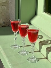 Pouring several glasses of Mexican Mezcal or Tequila shots. Classic Tequila small glasses being served.