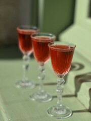 Pouring several glasses of Mexican Mezcal or Tequila shots. Classic Tequila small glasses being served.