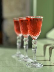 Pouring several glasses of Mexican Mezcal or Tequila shots. Classic Tequila small glasses being served.