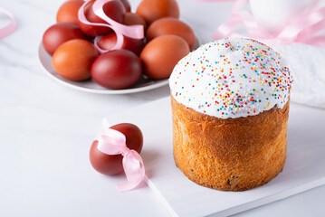 Delicious Easter cake and eggs on white background