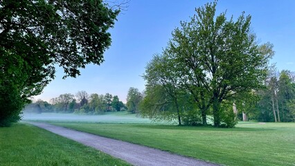 Sunrise and fog at dawn 5:00 AM end of April, Tiefurt Park in Weimar, Germany