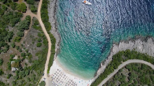 Rotating Top View over Ammoussa Beach Bay, Sun Umbrellas, Lefkada, Greece
