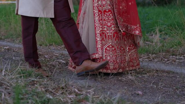 An Indian Hindu Groom and Bride Engaged in Conversation While Strolling Together During Their Wedding Celebration - Close Up