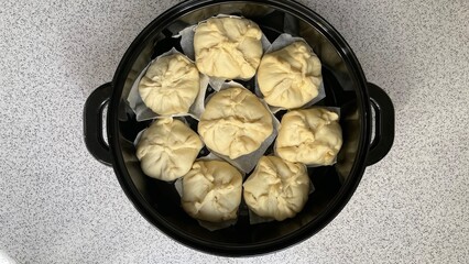 home made,Asian Steamed Bun using ready yeast dough sheet placed in rice cooker tray.