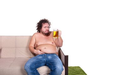 Funny fat man drinks beer and watches TV.
