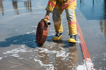 Firefighters practice building fire response plans using foam.