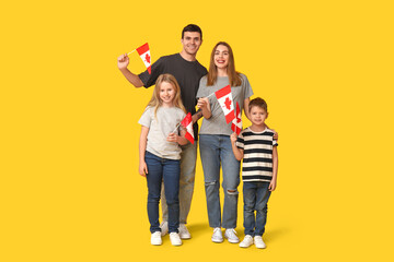 Happy family with flags of Canada on yellow background