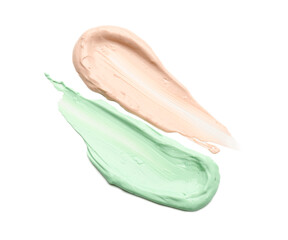 Strokes of pink and green color correcting concealers isolated on white, top view
