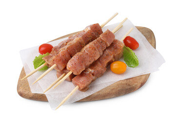 Wooden skewers with cut raw marinated meat isolated on white