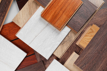 Different samples of wooden flooring as background, flat lay