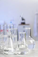 Laboratory analysis. Different glassware on light grey table indoors