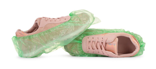 Sneakers in green shoe covers isolated on white