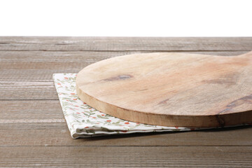 Cutting board and napkin on wooden table, closeup