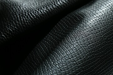 Black natural leather as background, closeup view