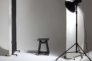 Studio Light Setup for Fashion Shoot. Beauty Dish Modifier on White Cyclorama with Polyboards and Stool.  - obrazy, fototapety, plakaty