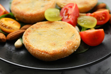 Plate with healthy dish high in vegetable fats on table, closeup