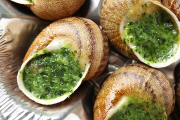 Delicious cooked snails on table, closeup view
