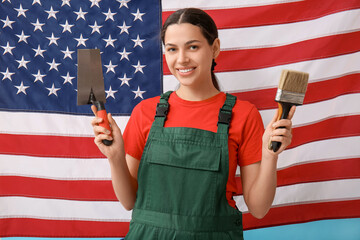 Female painter with trowel and paint brush against USA flag background
