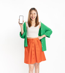 Cheerful beautiful Asian woman wearing green shirt and holding smartphone mockup of blank screen on white background.