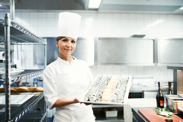 Chef, portrait and sushi with professional kitchen, cooking and hospitality industry employee....