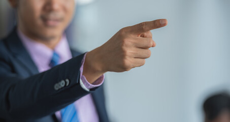 Businessman in suit pointing