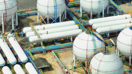 High above, an aerial drone showcases the silent guardians of energy, massive storage units nestled...