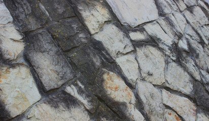 Old stones perfectly fitted to each other in the ancient wall of the fortress angle view
