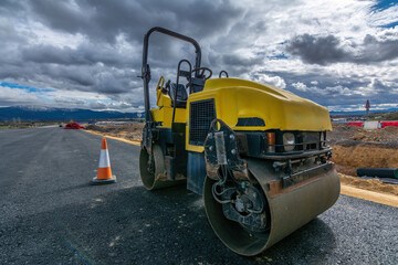 Small steamroller repairing a highway - obrazy, fototapety, plakaty