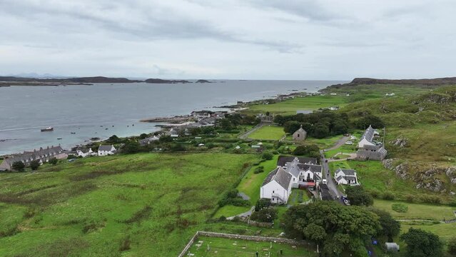 Aerial View of Iona Island, Scotland UK, Green Landscape and Waterfront Homes, Drone Shot 60fps