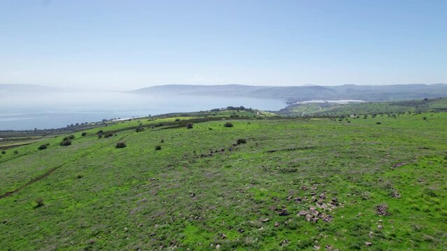 Drone shot of the Sea of Galilee revealed behind green hills2