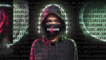 Cyber attack sd-wan text in foreground screen, anonymous hacker hidden with hoodie in the blurred background. Vulnerability text in binary system code on editor program.