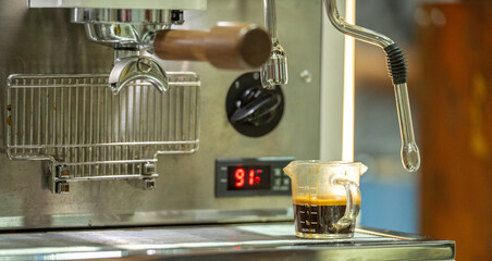 Barista making coffee with an espresso machine