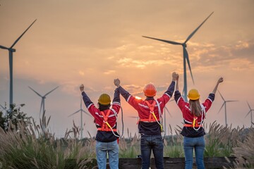 engineer technician team raise joy hand for success happiness at wind power plant machine ....