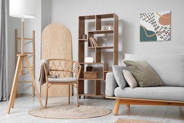 Armchair, sofa and shelving unit in stylish living room
