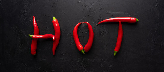 Red and hot Chili pepper on black background