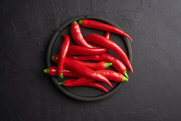 Red and hot Chili pepper on black background