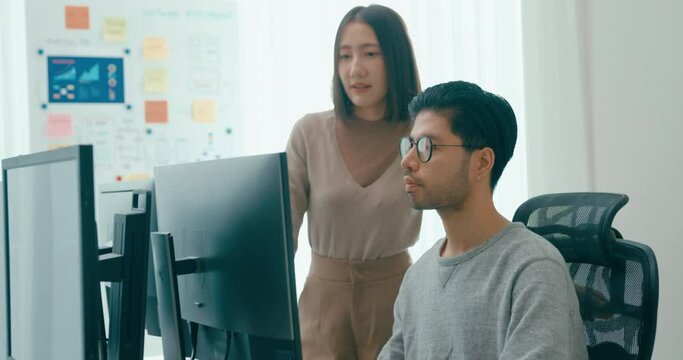 Group Adult Asia male, female freelance meeting write prompt AI bot IT app smart program nomad, video game, talk strategy, discuss plan, user interface, designer, big data center on desktop computer.