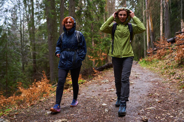 HIkers with backpacks on a trail in a rainy day - 800985063