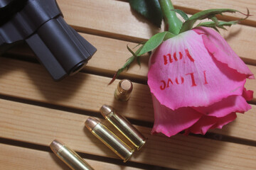 Vintage Gun With Bullets and Rose. Revolver and Ammunition