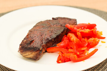 Prepared striploin steak with stewed pepper