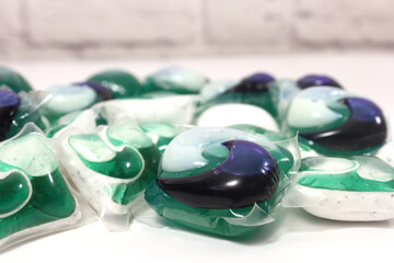 Pile of Green and White Laundry Pods on Table