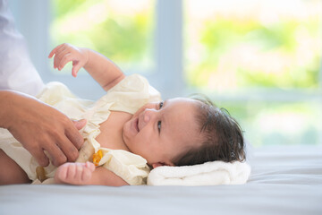 A mother plays with her little daughter in a bedroom full of warmth and family.