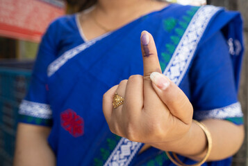 Voter shows inked finger after cast vote