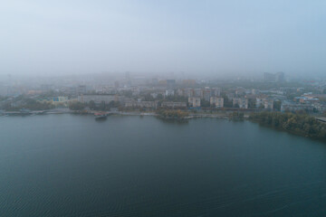 Aerial view of Dnipto city, Ukraine in fog. Cityscape. Panoramic view. Foggy metropolis. Ghost town. Atmospheric shot.