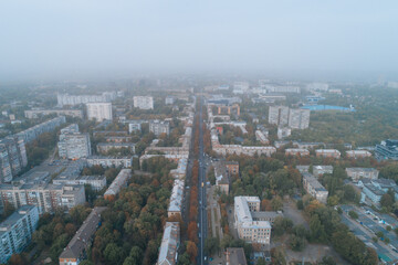 Obraz premium Aerial view of Dnipto city, Ukraine in fog. Cityscape. Panoramic view. Foggy metropolis. Ghost town. Atmospheric shot.