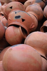 pots are gathered and arranged in a pattern in the empty space. The potter works on a pottery wheel to made of soft colored clay, retro style toned Clay pots with hand and equipment