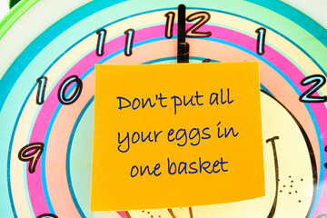 Concept Image. Do not put all your eggs in one basket Message on the sticker on the background of...