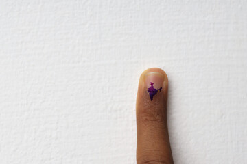 A finger with an electoral stain in the shape of India. Concept of election in India