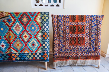 Colorful expensive vintage handmade oriental carpets on the market in Uzbekistan